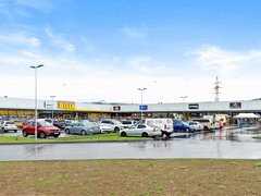 Retail park Odry, a row of units with parking in front of the entrances